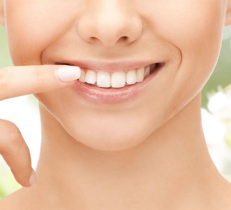 An image of a person smiling after receiving cosmetic dental treatment at VDSC Cosmetic Dentistry in Vancouver, BC