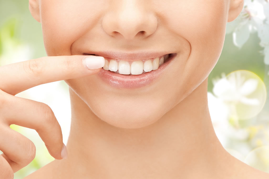 An image of a person smiling after receiving cosmetic dental treatment at VDSC Cosmetic Dentistry in Vancouver, BC