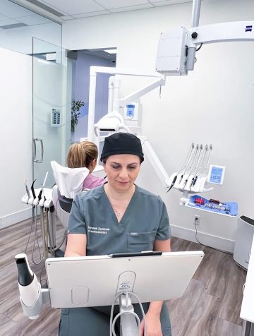 Dental specialist at VDSC review a patient chart in the treatment room.